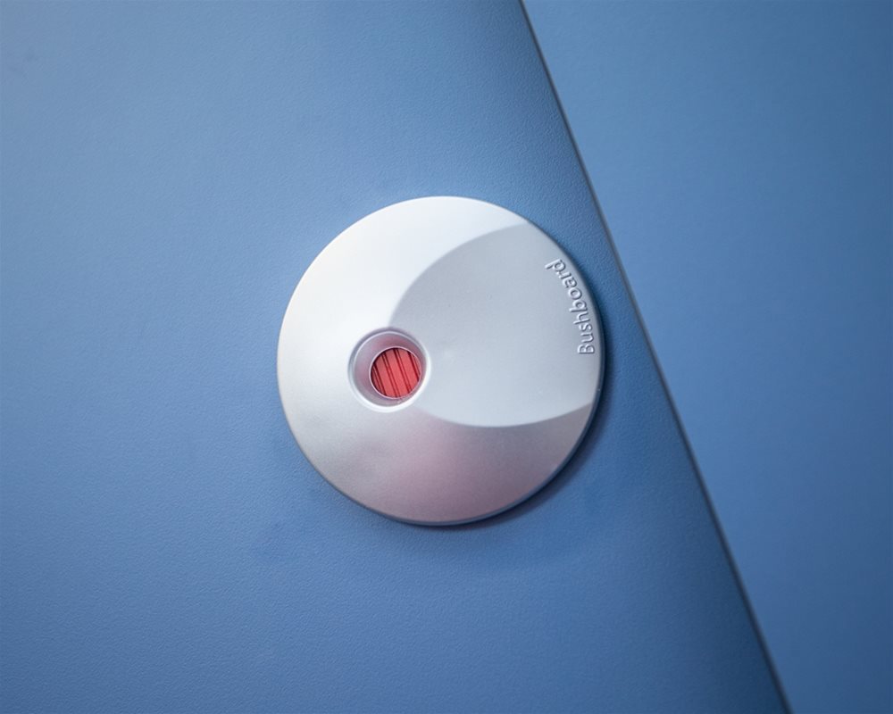Silver plastic lock faceplate with red indicator on 'Air Force Blue' toilet cubicle door.