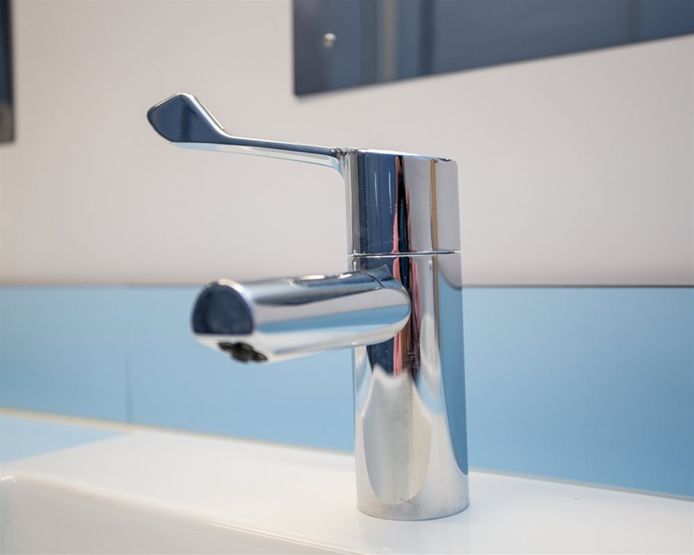 Basin mounted long lever Stainless Steel tap.