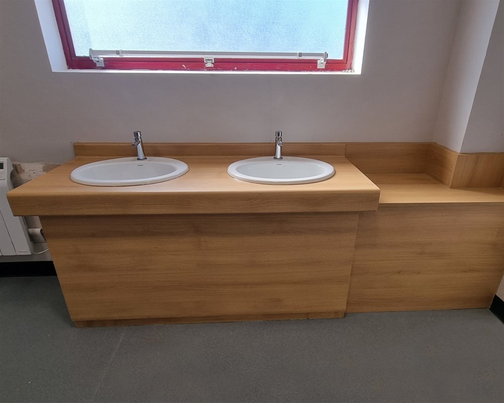 Washroom with Fast Track Quick Delivery Countertop Vanity Unit in Oak with lever mixer taps and oval basins