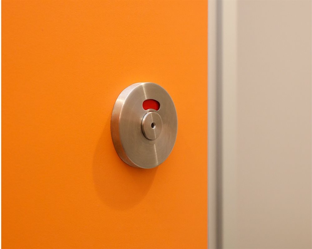 HiZone full height toilet cubicle lock faceplate with red 'engaged' colour showing on SGL door.