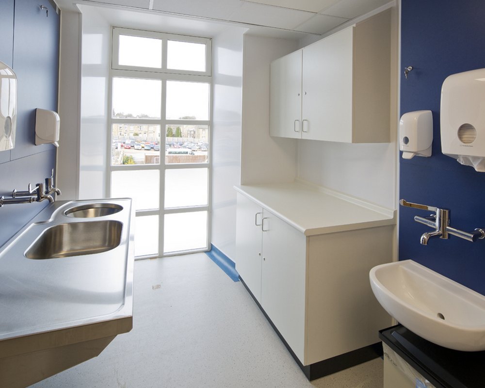 Acre Mills Hospital dirty utility room with healthcare stainless steel sinks.