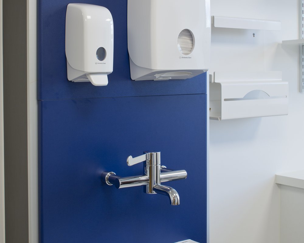 Blue healthcare boxed out unit with surgeons' mixer tap