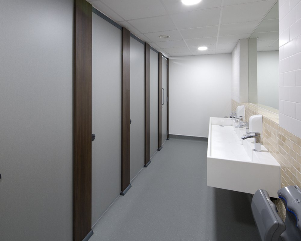 Full height HiZone toilet cubicles and white Solid Surface wash trough.