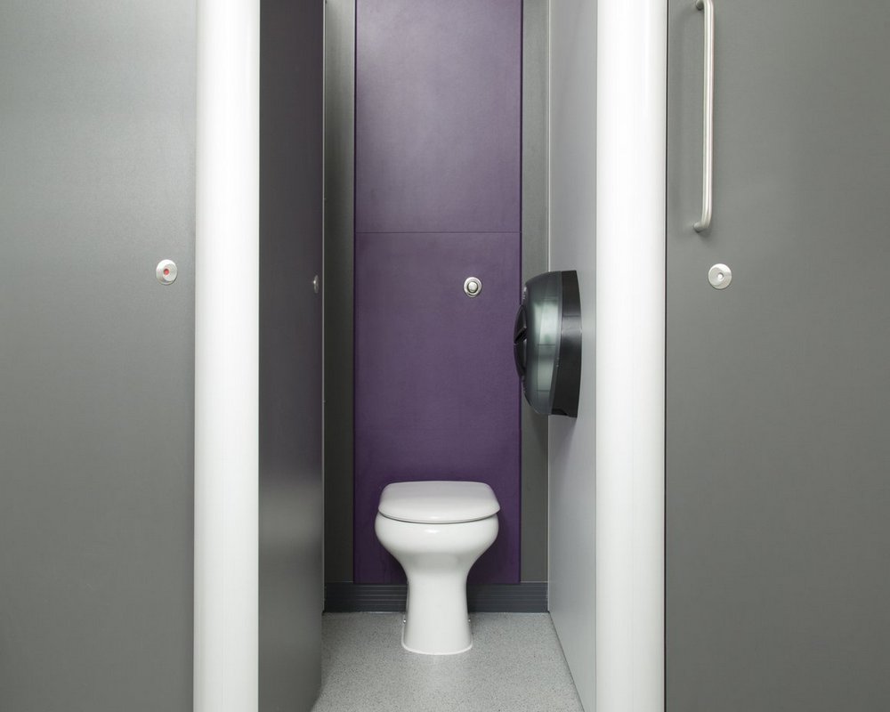 Huddersfield University inside toilet cubicle with Chartham white WC pan on purple panels