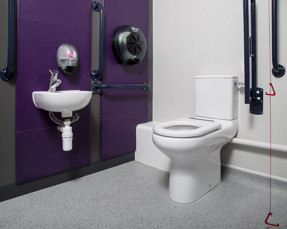 Huddersfield University Doc M accessible toilet with WC, basin and grabrails on purple panels