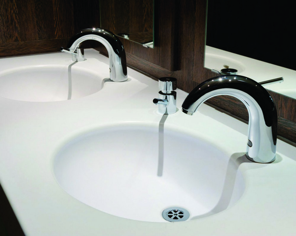 Integral Solid Surface basin in white 'Elysian' with sensor mixer tap and chrome soap dispenser and grid waste
