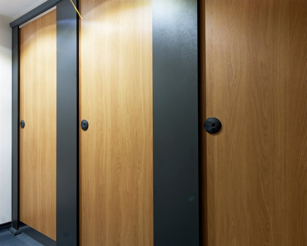 The Copper Kettle 'Quadro' toilet cubicles in European Oak and grey 'Welsh Slate'