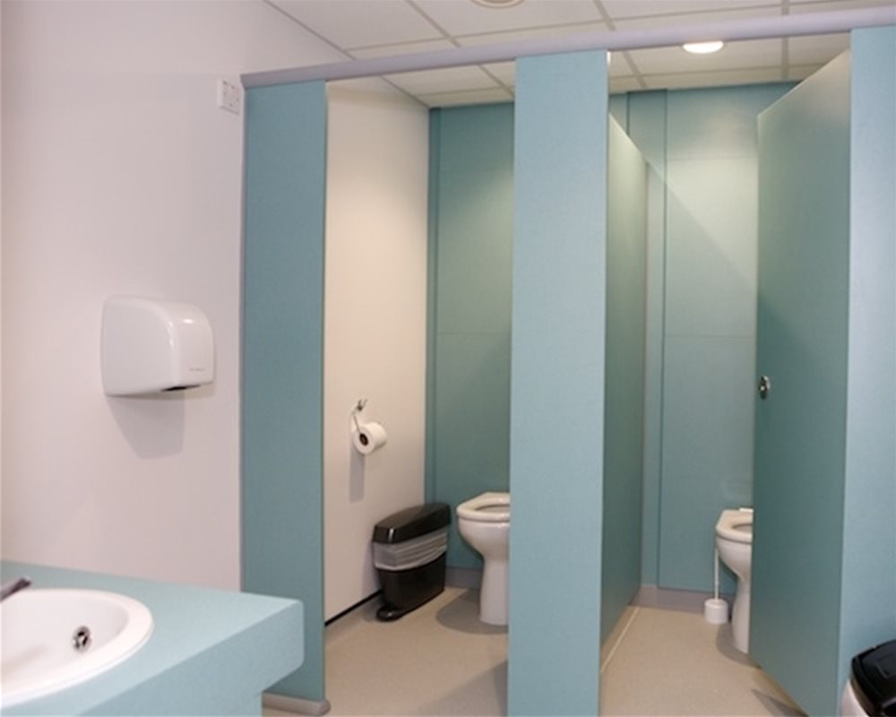 Quadro toilet cubicles in 'Bay Leaf' green and Chartham back to wall WCs 