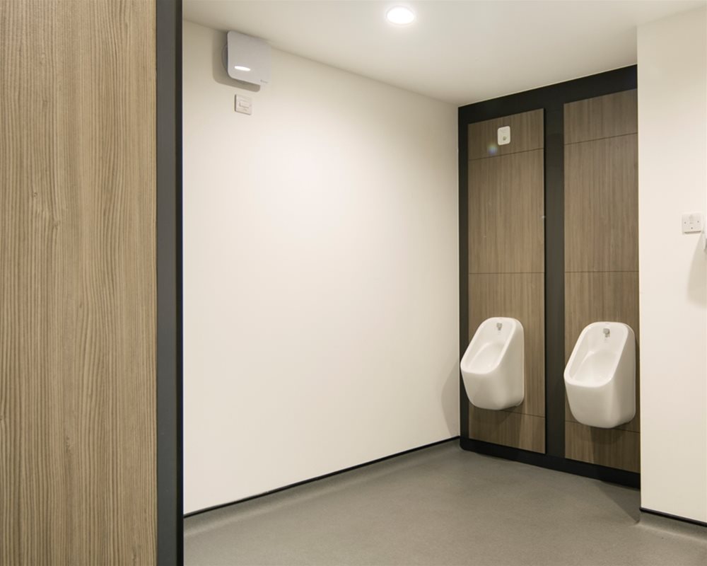 Marden white ceramic urinals pre-plumbed to 'Silver Oak' duct panels